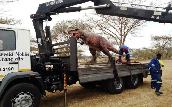 Picture of a dinosaur being loaded onto the HIAB truck