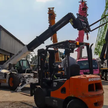 Picture of a forklift and bobcat parked next to each other