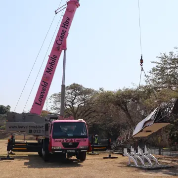 Picture of the Pink Lady crane lifting a stadium light