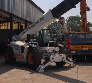 Picture of a white bobcat with a fork attachment